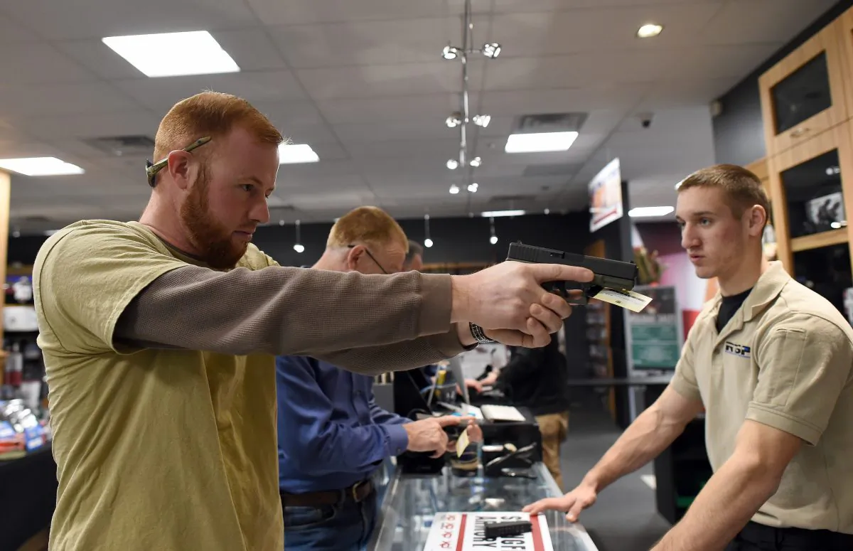 A man checks out a handgun for sale at the RTSP shooting range in Randolph, N.J., on Dec. 9, 2015. (Jewel Samad/AFP/Getty Images)