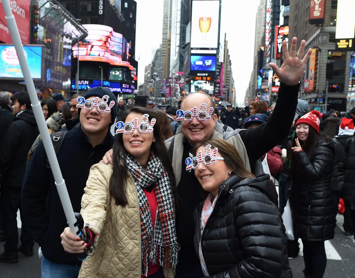 Revelers take selfies as they gather in Times Square ahead of the ball drop in New York on Dec. 31, 2015. (Don Emmert/AFP/Getty Images)