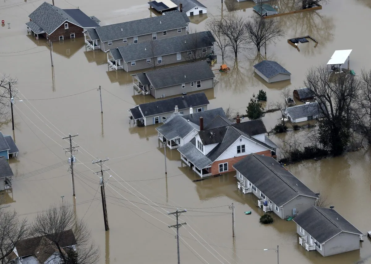 In this aerial photo, homes are surrounded by floodwater, Wednesday, Dec. 30, 2015, in Pacific, Mo. (AP Photo/Jeff Roberson)