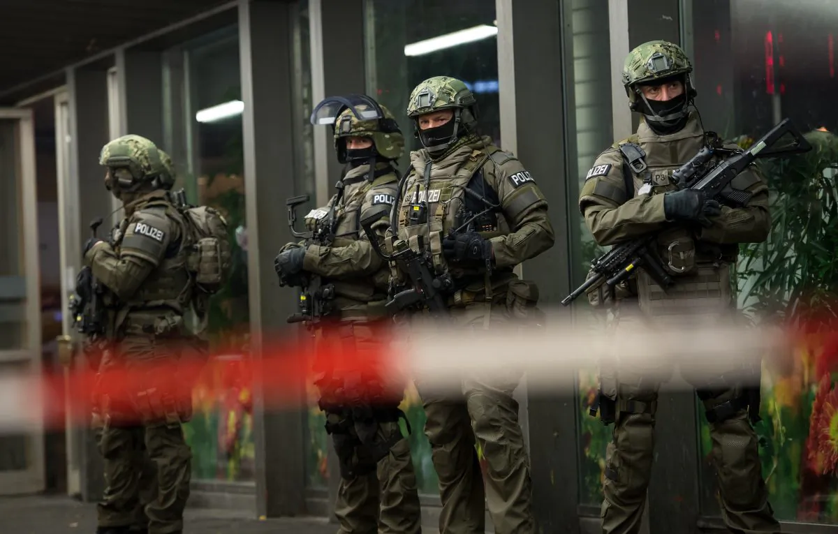 German special police stand in front of the Munich, southern Germany, main train station Thursday evening, Dec. 31, 2015 after police warned of 'imminent threat' of terror attack and ordered two train stations to be cleared. (Sven Hoppe/dpa via AP)