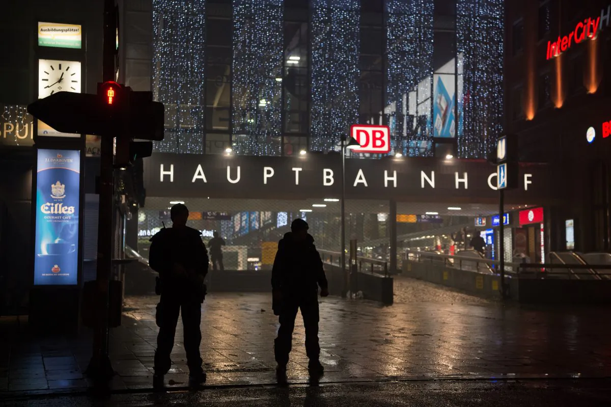 German special police stand in front of the Munich, southern Germany, main train station Thursday evening, Dec. 31, 2015 after police warned of 'imminent threat' of terror attack and ordered two train stations to be cleared. (Sven Hoppe/dpa via AP)