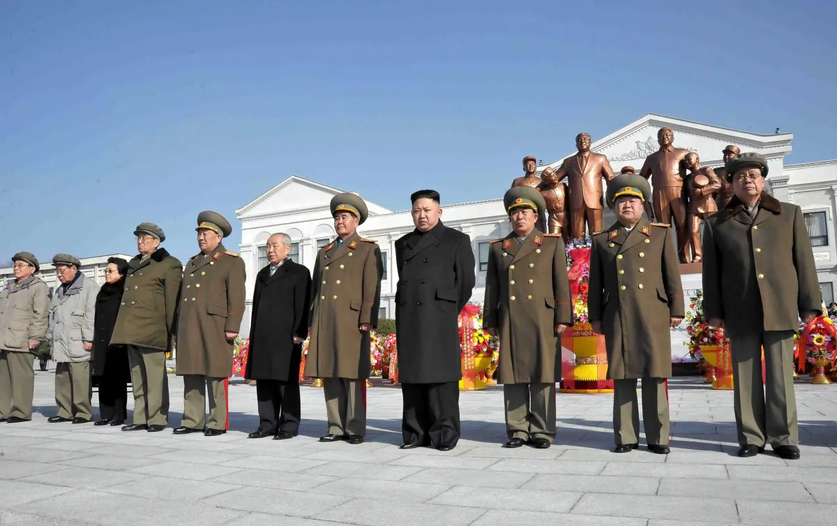 North Korean leader Kim Jong-un (4th R) and senior senior officials from the party, government and army posing before the statues of late leaders Kim Il-sung and Kim Jong-il at Mangyongdae Revolutionary School in Pyongyang as the statues were unveiled on the birth anniversary of Kim Jong-il, on on Feb. 16, 2013. (Korean Central News Agency via Getty Images)