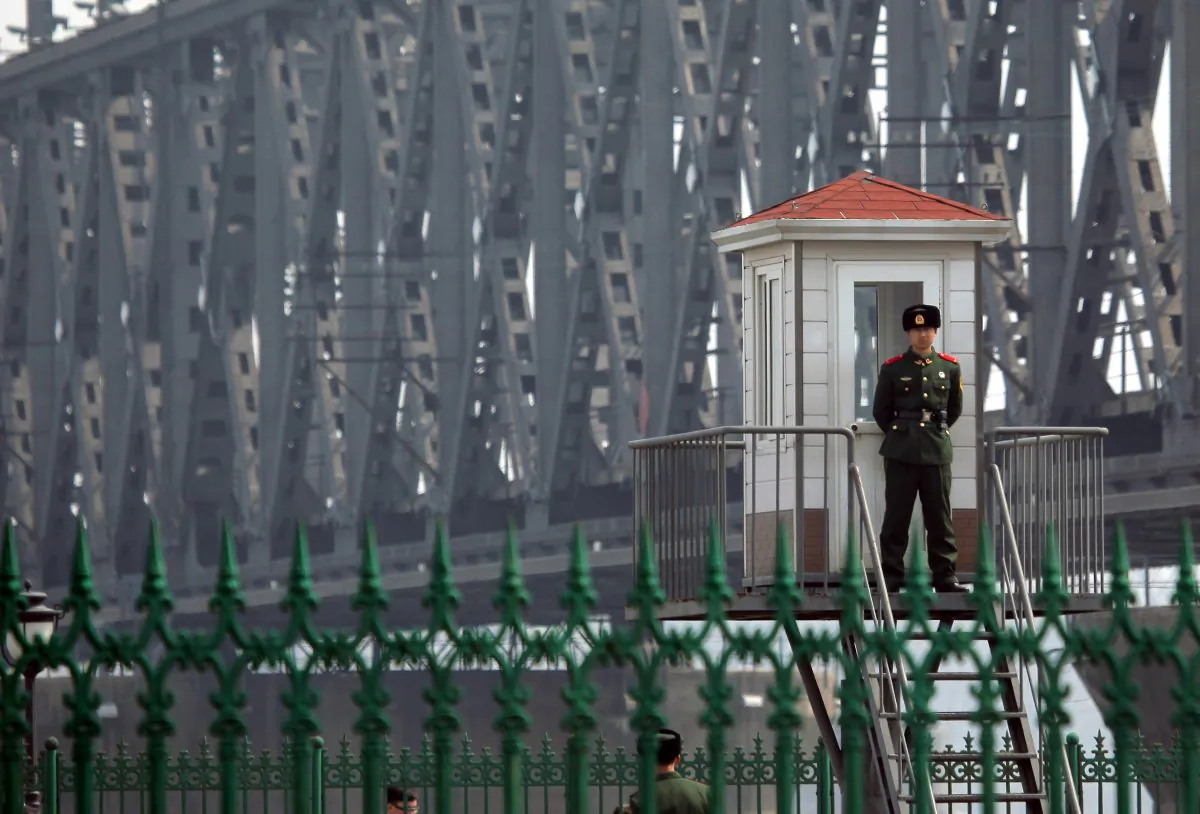 A Chinese border guard standing on a look out post by the bridge that crosses the Yalu river to the North Korean town of Sinuiju across from the city of Dandong on April 6, 2013. (STR/AFP/Getty Images)