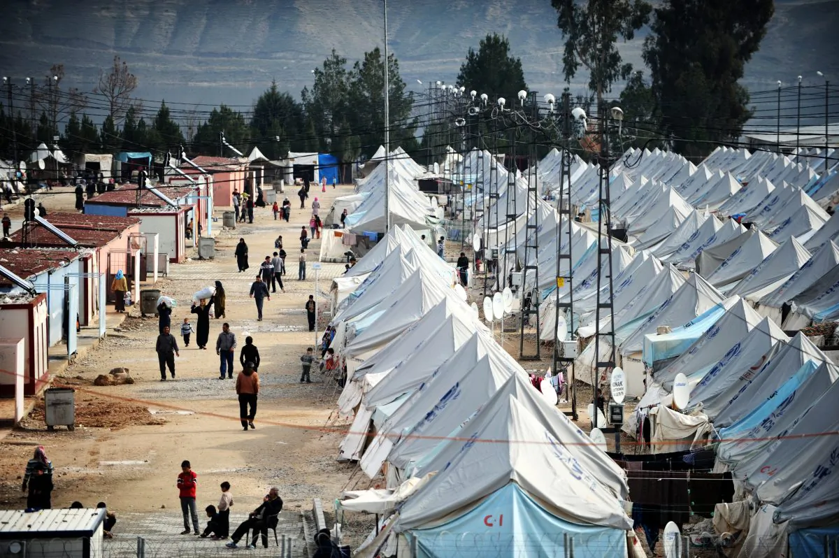 Syrian refugees walk among tents at Karkamis' refugee camp near the town of Gaziantep, south of Turkey, on on Jan. 16, 2014. (Ozan Kose/AFP/Getty Images)
