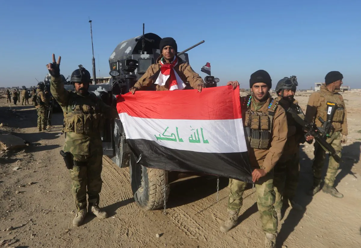 Members of Iraq's elite counterterrorism service pose with their national flag on Dec. 29, 2015, in the city of Ramadi, the capital of Iraq's Anbar Province, after Iraqi forces recaptured it from the Islamic State. (Ahmad al-Rubaye/AFP/Getty Images)