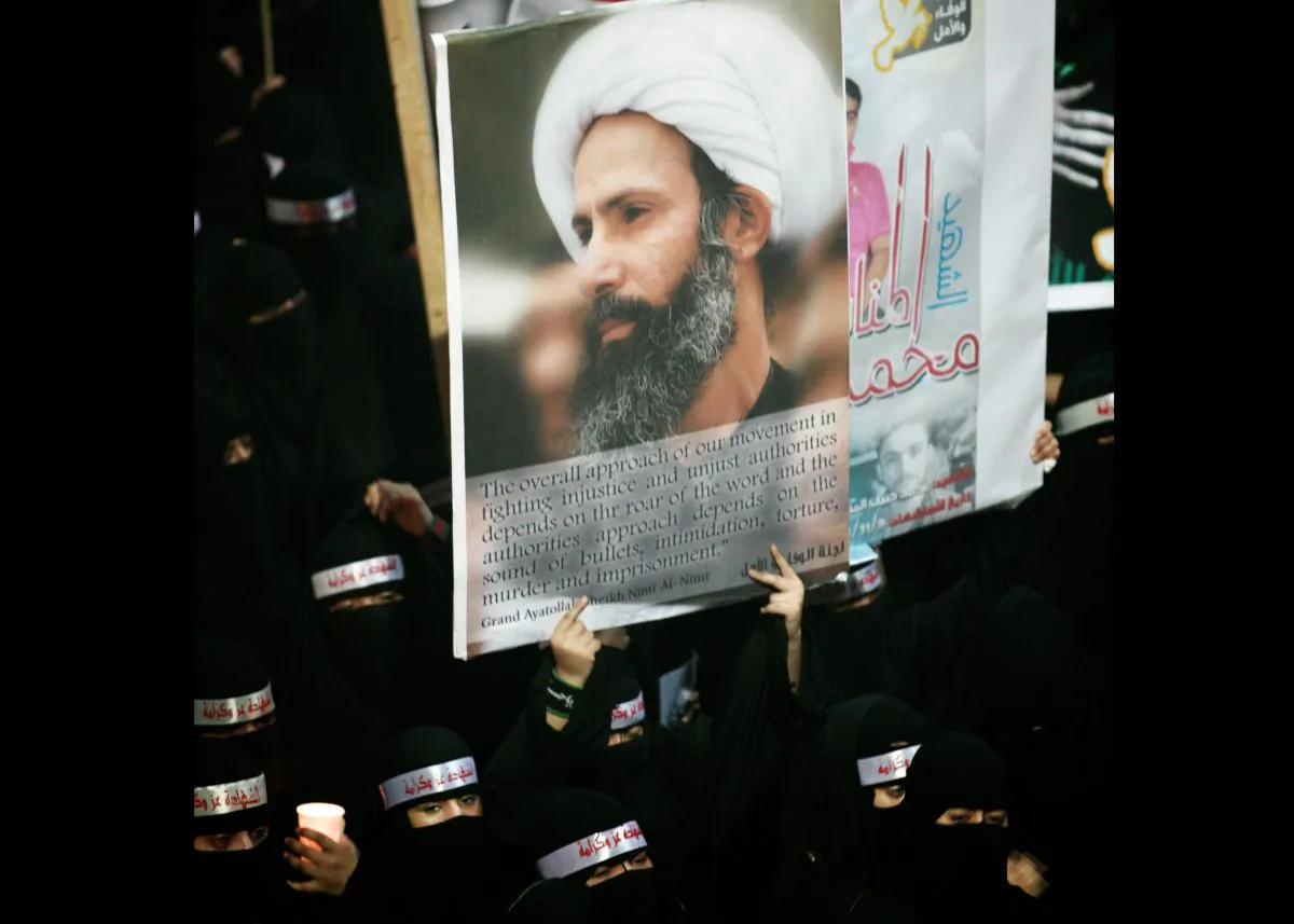 A Saudi anti-government protester carries a poster with the image of jailed Shiite cleric Sheik Nimr al-Nimr during the funeral of three Shiite Muslims allegedly killed by Saudi security forces in the eastern town of al-Awamiya, Saudi Arabia, on Sept. 30, 2012. Saudi Arabia says it has executed 47 prisoners, including leading Shiite cleric Sheikh Nimr al-Nimr. The cleric’s name was among a list of the 47 prisoners executed carried by the state-run Saudi Press Agency. It cited the Interior Ministry for the information. (AP Photo)