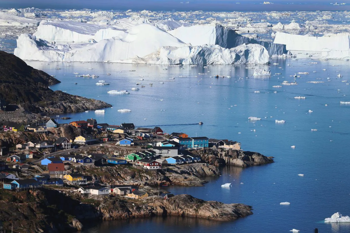 The village of Ilulissat is seen near the icebergs that broke off from the Jakobshavn Glacier in Ilulissat, Greenland, on July 24, 2013. (Joe Raedle/Getty Images)