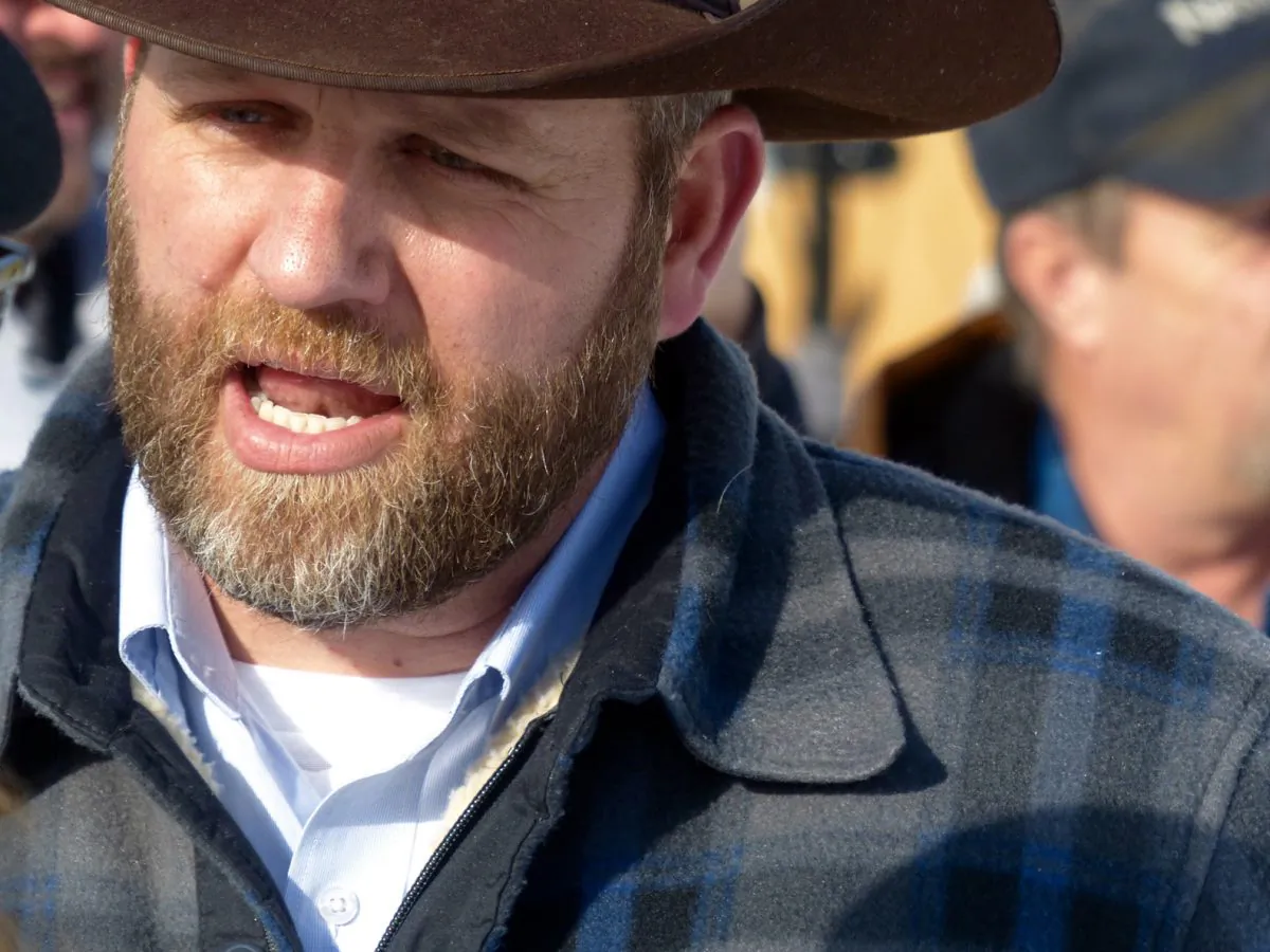 Ammon Bundy chats with a protester during a march on behalf of a Harney County ranching family in Burns, Ore., on Jan. 2, 2016. (Les Zaitz/The Oregonian via AP)