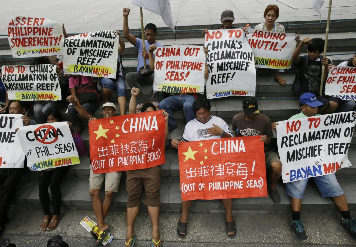 Protesters display placards during a rally at the Chinese Consulate at the financial district of Makati city, east of Manila, Philippines, on April 17, 2015, to protest moves by China in "fortifying" its claims at the disputed Spratlys Islands in the South China Sea. China’s campaign of island building in the South China Sea might soon quadruple the number of airstrips available to the People’s Liberation Army in the highly contested and strategically vital region. That could be bad news for other regional contenders, especially the U.S., the Philippines, and Vietnam. (AP Photo/Bullit Marquez)