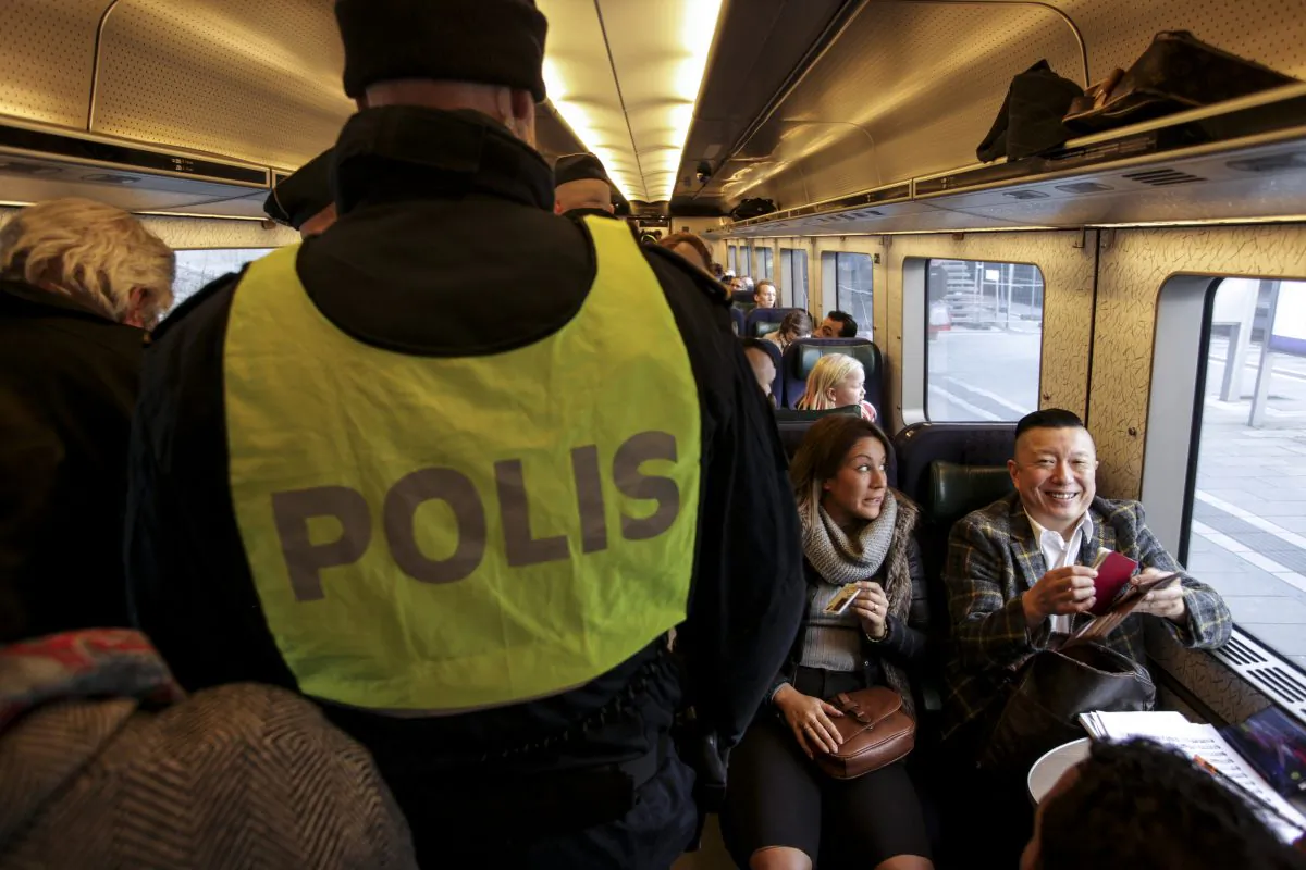 Swedish police officers on the train from Copenhagen in Malmo, Sweden, on Nov. 12, 2015. (Stig Ake Jonsson/TT via AP)