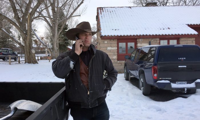 Ryan Bundy talks on the phone at the Malheur National Wildlife Refuge near Burns, Ore., Sunday, Jan. 3, 2016. Bundy is one of the protesters occupying the refuge to object to a prison sentence for local ranchers for burning federal land. (AP Photo/Rebecca Boone)