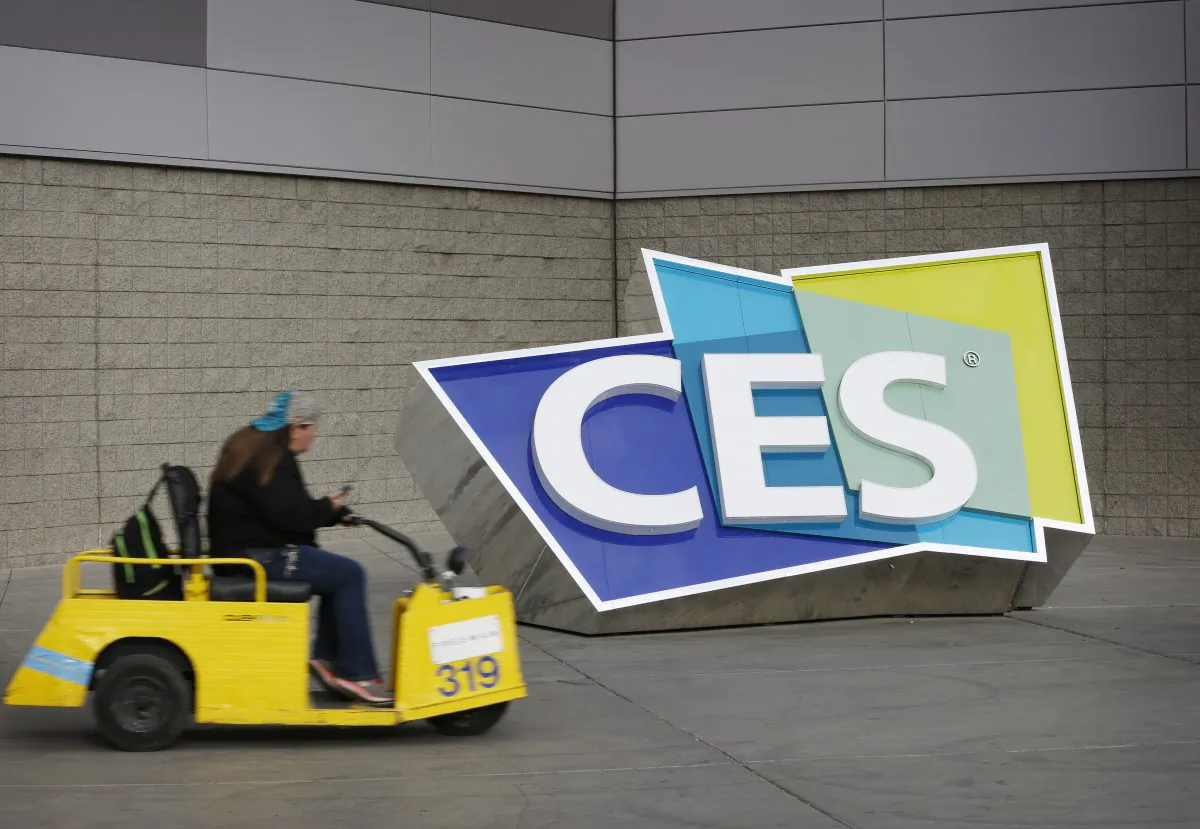 A worker drives by a sign at the Las Vegas Convention Center before the start of the International CES gadget show in Las Vegas on Jan. 3, 2016. The show officially kicks off Wednesday, Jan. 6. (AP Photo/John Locher)