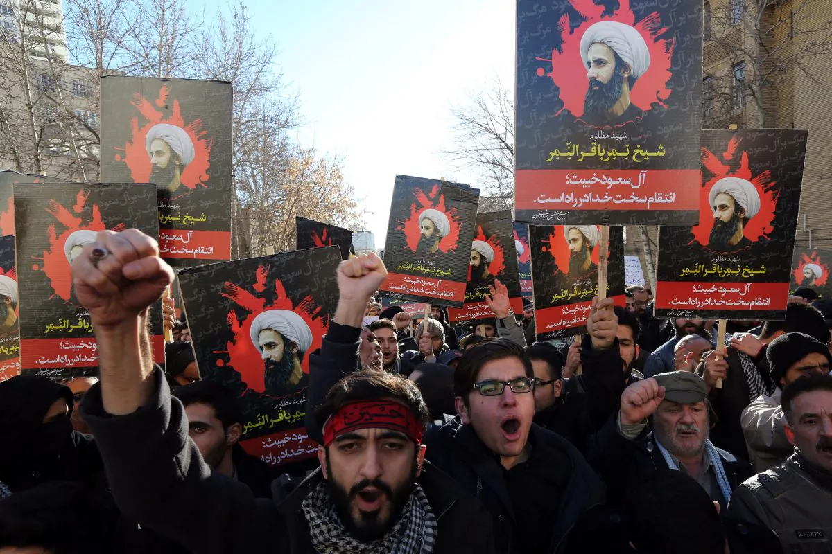 Iranian men hold portraits of Shia cleric Sheik Nimr al-Nimr during a demonstration against his execution by Saudi authorities, on Jan. 3, 2016, outside the Saudi embassy in Tehran. Iran and Iraq's top Shiite leaders condemned Saudi Arabia's execution of Nimr, warning ahead of protests that the killing was an injustice that could have serious consequences. (Atta Kenare/AFP/Getty Images)