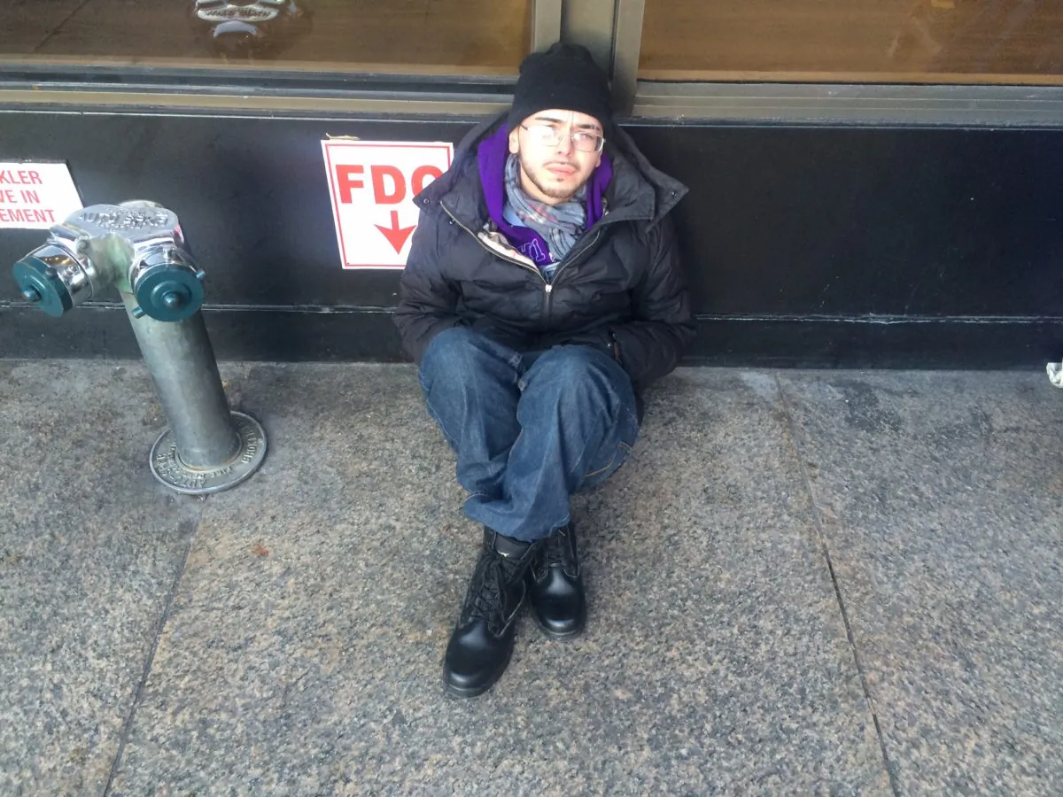 Anthony Gonsalez, 29, homeless for 2 years, sits in the cold near Penn Station in New York. 