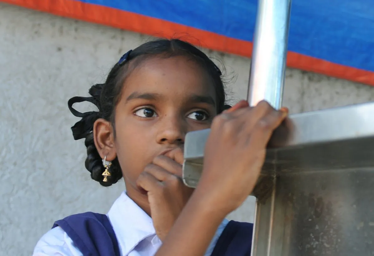 An Indian schoolgirl stands at her father's temporary tea stall in Hyderabad on Oct. 11, 2012, on the occasion of the first 'International Day of the Girl Child.' (Noah Seelam/AFP/GettyImages)