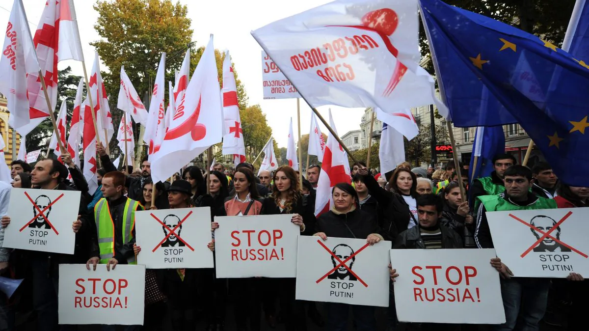 Georgian opposition supporters hold flags and posters during their rally in central Tbilisi, Georgia, on Nov. 15, 2014. Over 30,000 opposition supporters rallied today in the Georgian capital against the government's Russian policy and the Kremlin's backing of separatists in the breakaway Abkhazia and South Ossetia regions. (Vano Shlamov/AFP/Getty Images)