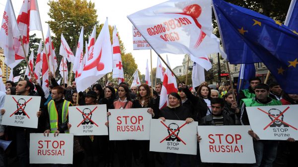 Georgian opposition supporters hold flags and posters during their rally in central Tbilisi, Georgia, on Nov. 15, 2014. Over 30,000 opposition supporters rallied today in the Georgian capital against the government's Russian policy and the Kremlin's backing of separatists in the breakaway Abkhazia and South Ossetia regions. (Vano Shlamov/AFP/Getty Images)