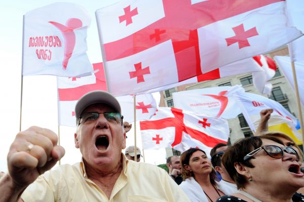 Protesters wave Georgia's national flag, also known as the Five Cross Flag, as they take part in a rally against Russia in Tbilisi on July 18, 2015. Over 3,000 people took to the streets in Georgia on Saturday to protest what they called Moscow's occupation of the breakaway South Ossetia and Abkhazia regions. (Vano Shlamov/AFP/Getty Images)