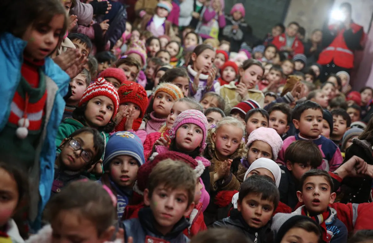 Syrian children attend an event organised by the Syrian Arab Red Crescent for New Year's eve celebrations in a rebel-controlled area of Arbeen, on the outskirts of the capital Damascus, on Dec. 31, 2015. (Abd Doumany/AFP/Getty Images)