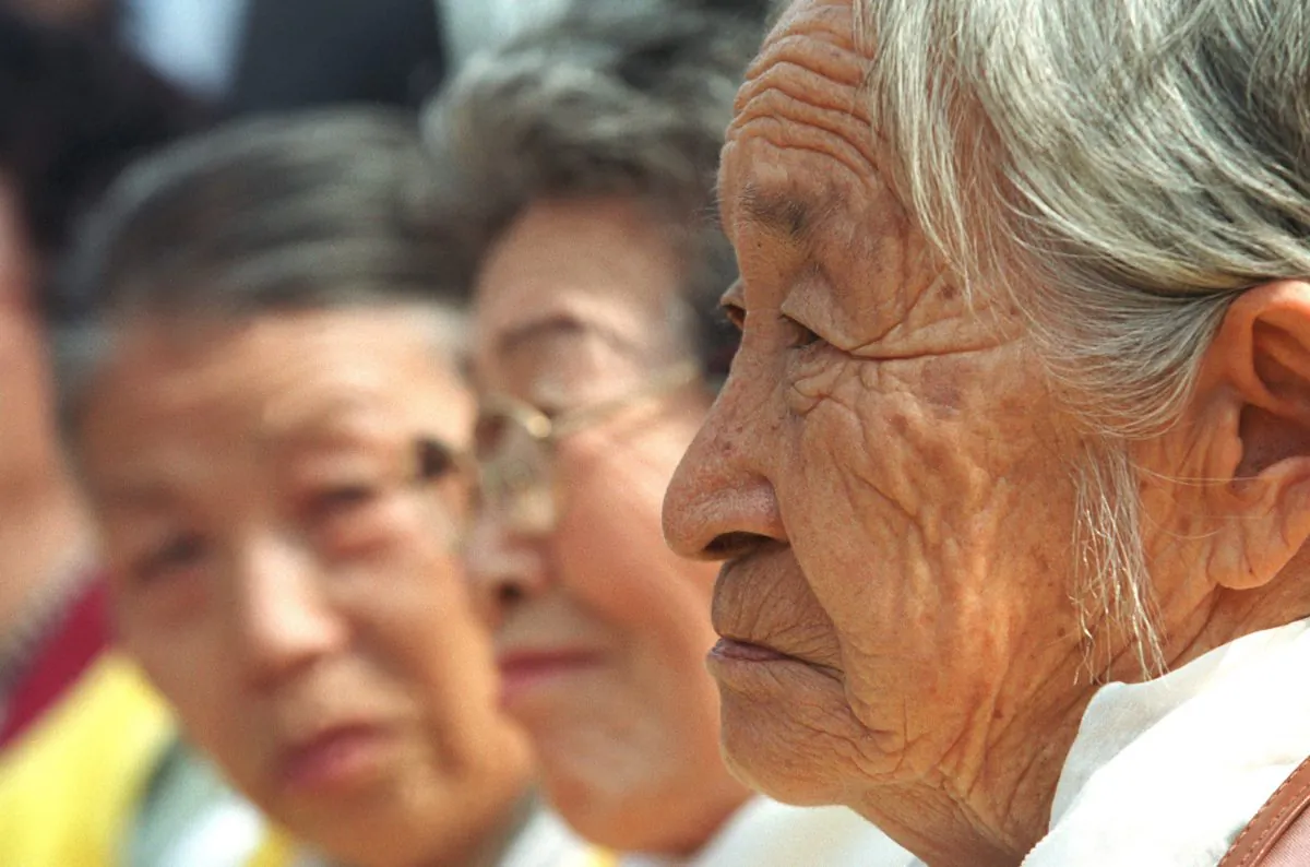 Moon Pil-Ki (R), a former World War II South Korean comfort woman, attends a protest in front of the Japanese Embassy on March 13, 2002, during the 500th weekly anti-Japan rally in Seoul, South Korea. Comfort women were forced to entertain Japanese soldiers during World War II. (Chung Sung-jun/Getty Images)