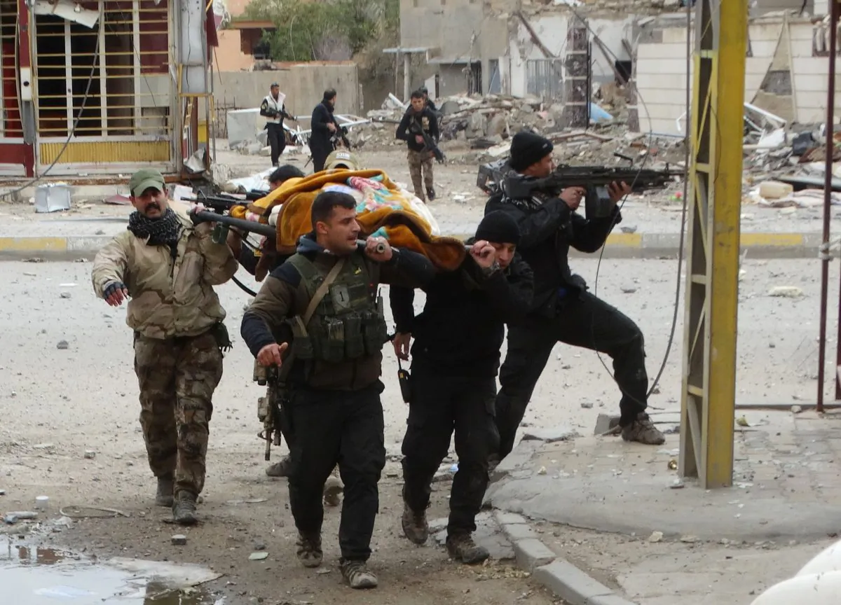 Iraqi security forces and allied Sunni tribal fighters evacuate an injured woman after she was shot by Islamic State fighters as she tried to cross from neighborhoods under control of ISIS to neighborhoods under control of Iraqi security forces in Ramadi, 70 miles (115 kilometers) west of Baghdad, Iraq, on Jan. 4, 2016. Iran is a key ally of the Shiite-led government in Baghdad, has helped it in the fight against the Islamic State group and supports powerful Shiite militias in the country. But at the same time, Baghdad is trying to rebuild long strained ties with Saudi Arabia–which only last week sent an ambassador to Baghdad for the first time in 25 years. (AP Photo)