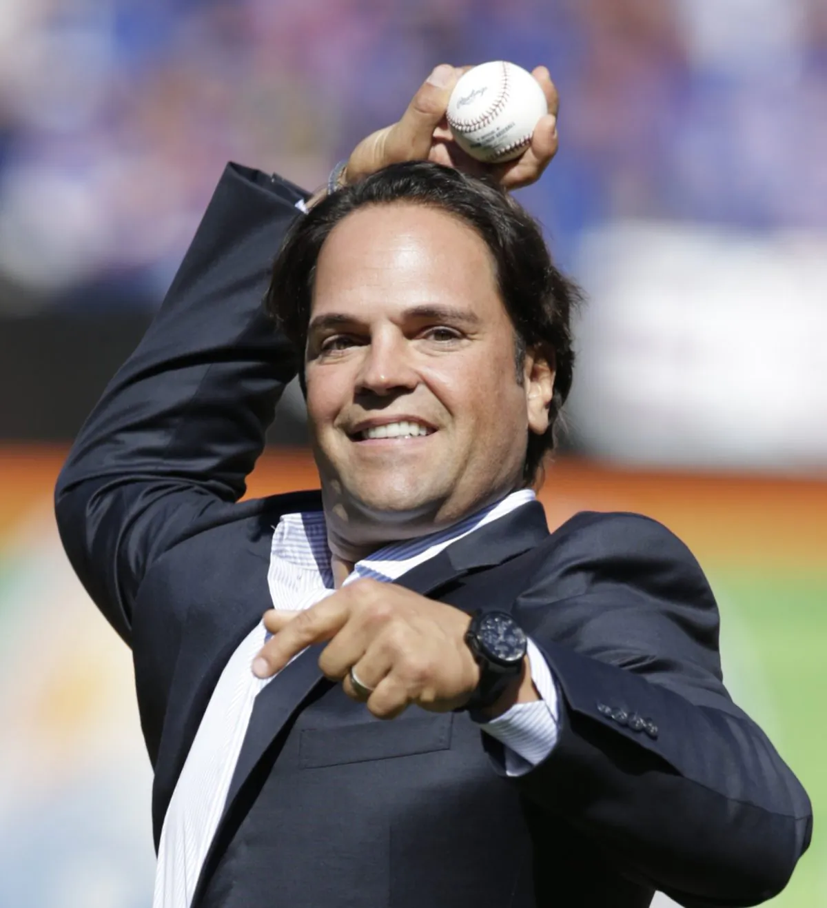 Former New York Mets catcher Mike Piazza throws out the ceremonial first pitch before a baseball game against the Milwaukee Brewers, following a ceremony inducting him into the Mets Hall of Fame, in New York. (AP Photo/Kathy Willens, File)