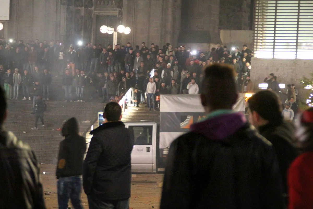 Persons gather at the Cologne, Germany, main station on Dec. 31, 2015. German police said Jan. 6, 2016, that they are investigating whether a string of sexual assaults and thefts at New Year is linked to a known criminal network. The assaults in Cologne last week have prompted outrage in Germany and a fresh debate about immigration, after police said the perpetrators appeared to be of "Arab or North African origin." The events in Cologne involved a crowd of around a thousand men. Police say at least 90 criminal complaints were filed, and that some men in the crowd formed smaller groups and surrounded women. (Markus Boehm/dpa via AP)