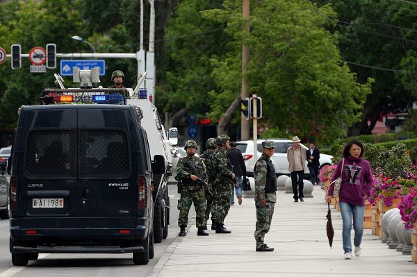 Chinese paramilitary police officers stand guard along a street in Urumqi on May 23, 2014. Xiu Hui, the head of security bureau, labor camp and prison in Xinjiang, was placed under investigation in January 2016. (Goh Chai Hin/AFP/Getty Images)