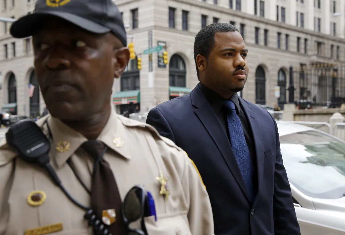 Officer William Porter, right, one of six Baltimore city police officers charged in connection to the death of Freddie Gray, walks into a courthouse during jury deliberations, Wednesday, Dec. 16, 2015, in Baltimore. (AP Photo/Patrick Semansky)