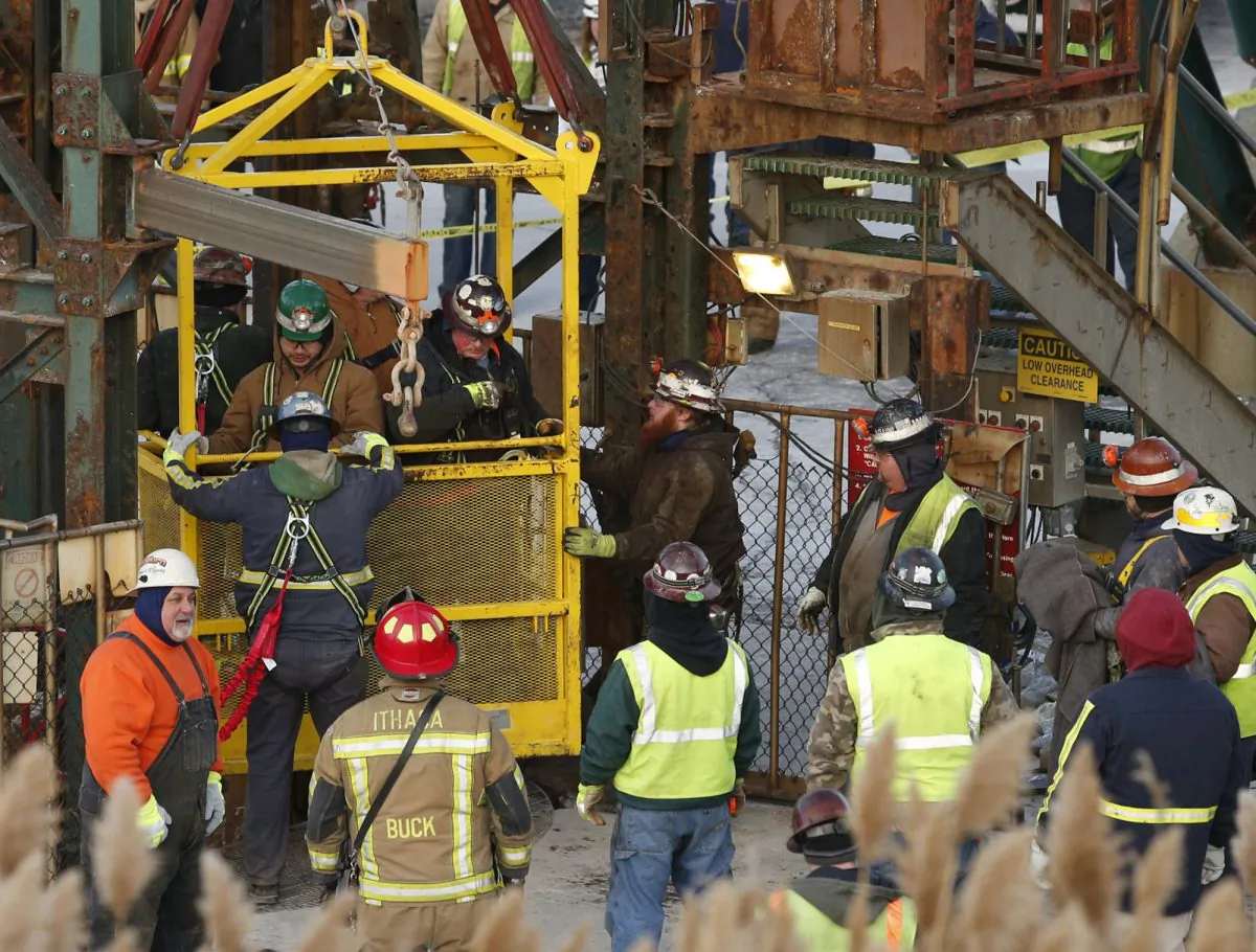 The fourth group of workers emerge from an elevator on Jan. 7, 2016, after they were stuck overnight in a shaft at the Cayuga Salt Mine in Lansing, N.Y. (Simon Wheeler/The Ithaca Journal via AP, Pool)