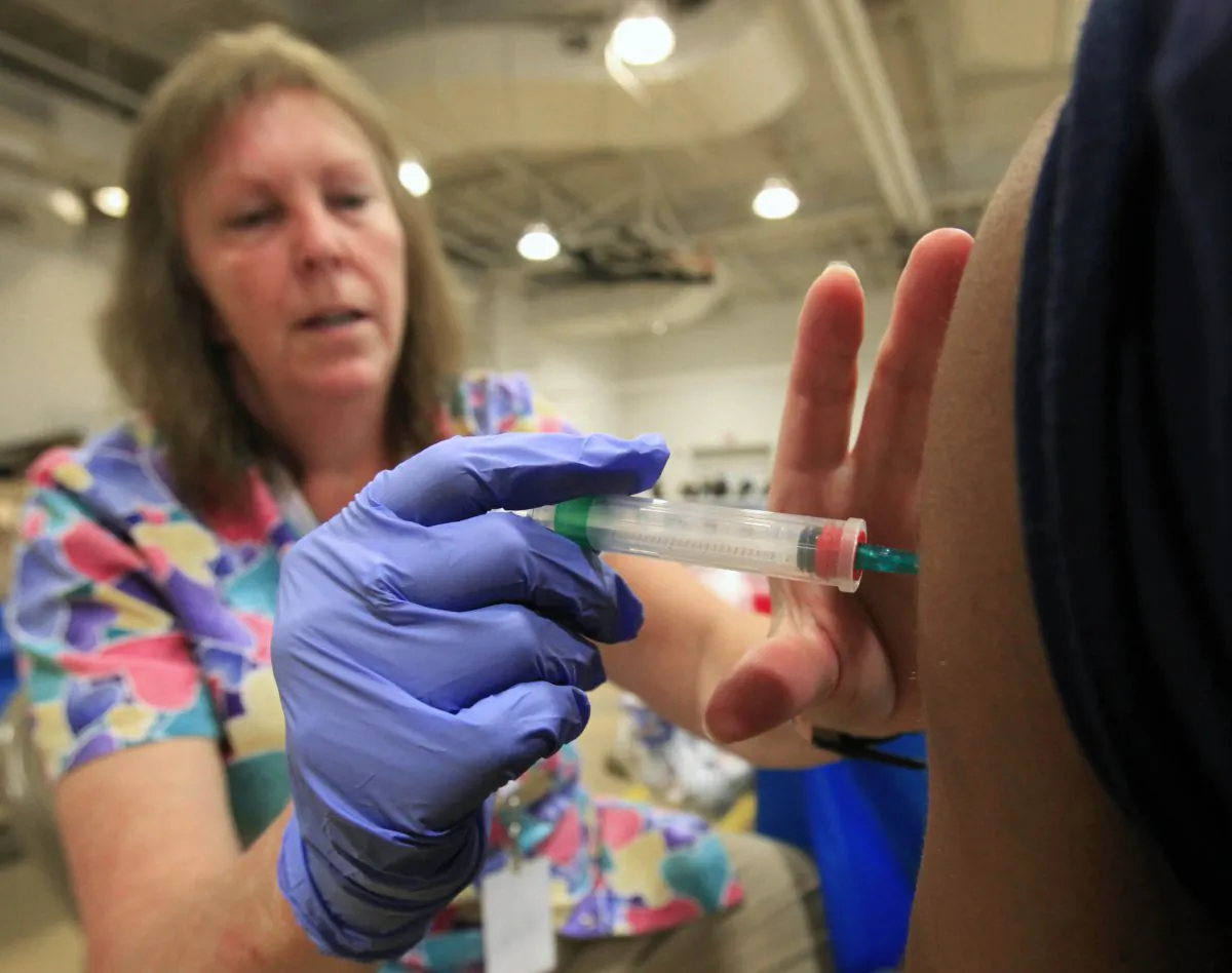 A nurse gives a whooping cough vaccination to a student at Inderkum High School in Sacramento, Calif., on Sept. 19, 2011. (Rich Pedroncelli/AP Photo)