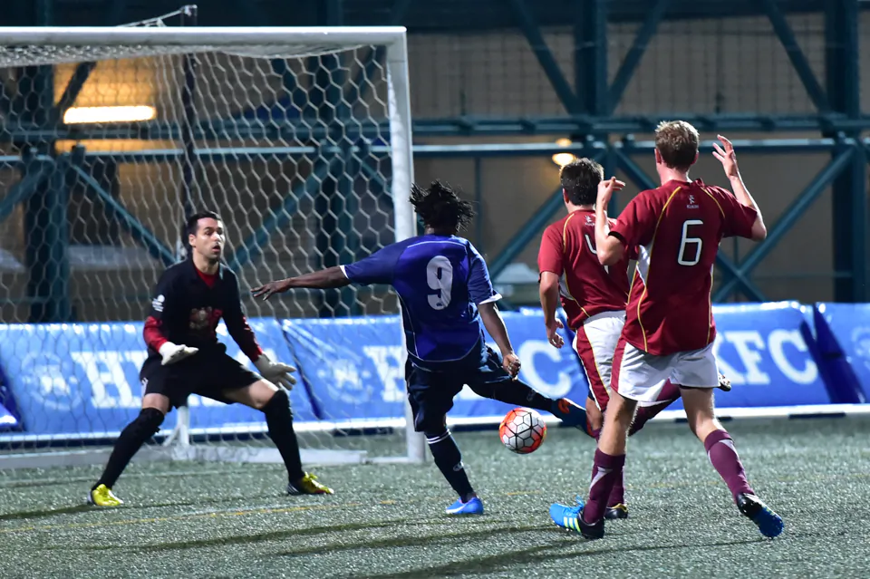 Sean Tunde Olokigbe (blue) scores Albion's second goal in their 8-nil YYL Cup third round defeat of Dynamo at Sports Road on Sunday Jan 3, 2016. (Bill Cox/Epoch Times)