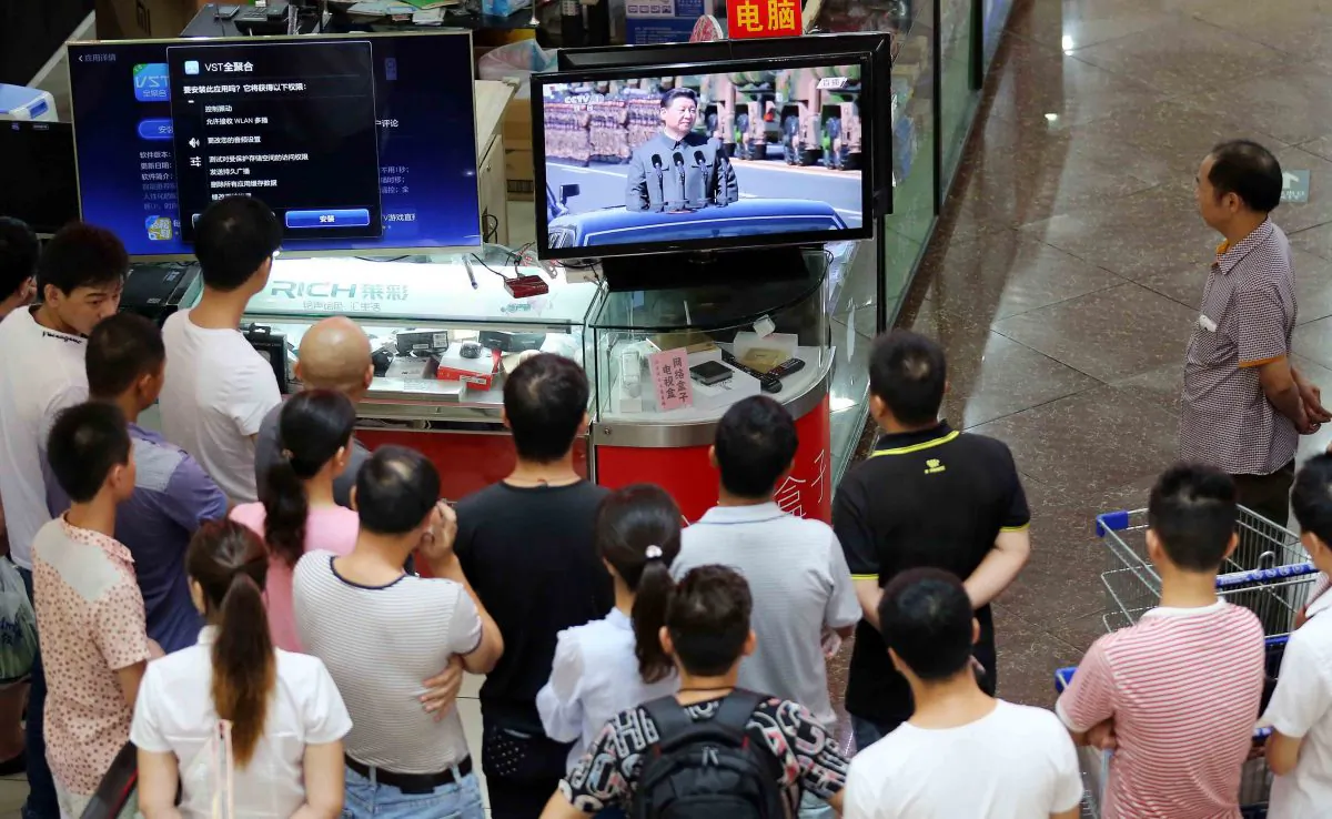 People gather in front of a television east China's Fujian Province on Sept. 3, 2015. (STR/AFP/Getty Images)