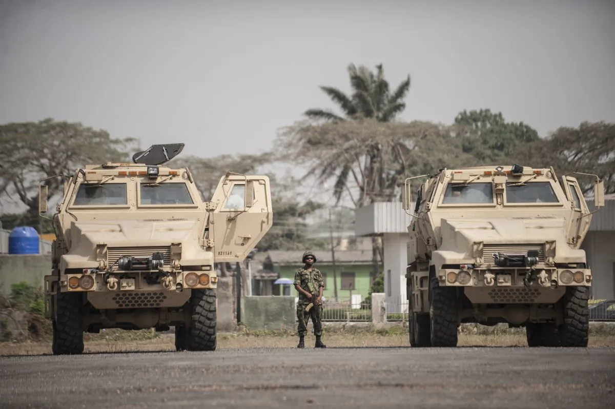 A Nigerian soldier stands between the 24 armoured vehicles donated by the United States to the Nigerian military at the Nigerian Army 9th Brigade Parade Ground in Lagos on Jan. 7, 2016. (Stefan Heunis/AFP/Getty Images)