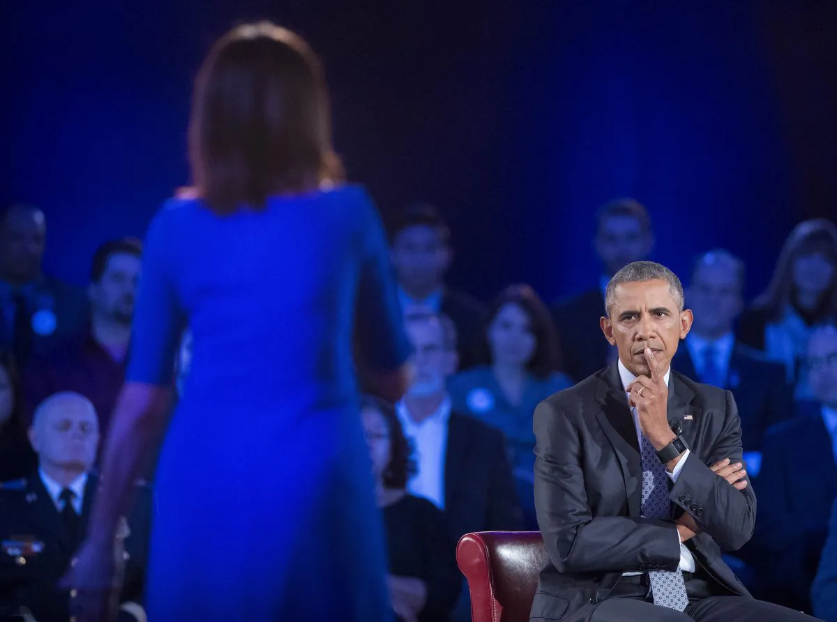 President Barack Obama, right, listens to a question from Taya Kyle, left, widow of U.S. Navy SEAL Chris Kyle, during a CNN televised town hall meeting hosted by Anderson Cooper at George Mason University in Fairfax, Va., Thursday, Jan. 7, 2016. (AP Photo/Pablo Martinez Monsivais)