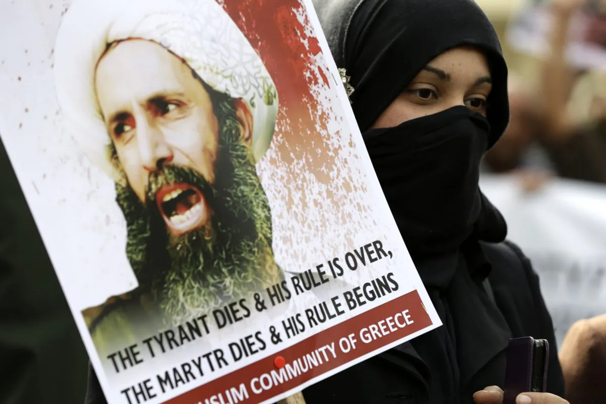 A Shia Muslim who lives in Greece takes part in a rally against the execution of cleric Sheikh Nimr al-Nimr, outside Saudi Arabia's Embassy in Athens on Jan. 6, 2016. (AP Photo/Thanassis Stavrakis)