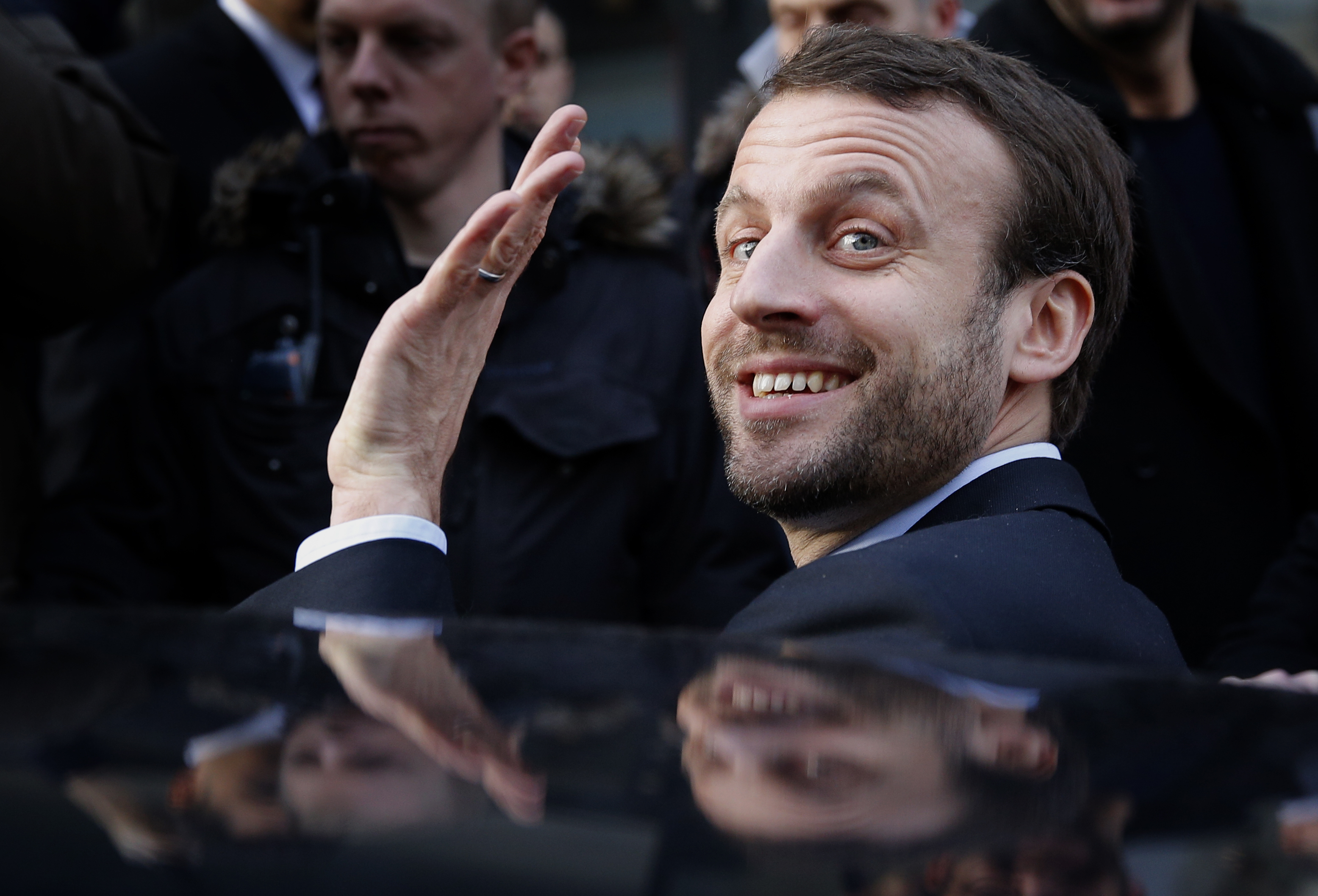 French Economy Minister Emmanuel Macron waves as he leaves after a visit to a shopping center on the first day of the winter sales in Paris on Jan. 6, 2016. The five-week 2016 winter sales start everywhere across France on Wednesday jan.6 and end on Feb. 16. (AP Photo/Christophe Ena)
