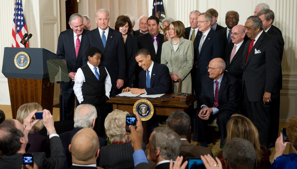 President Barack Obama signs the health care insurance reform legislation during a ceremony in the East Room of the White House in Washington, D.C., on March 23, 2010. (Saul Loeb/AFP/Getty Images)