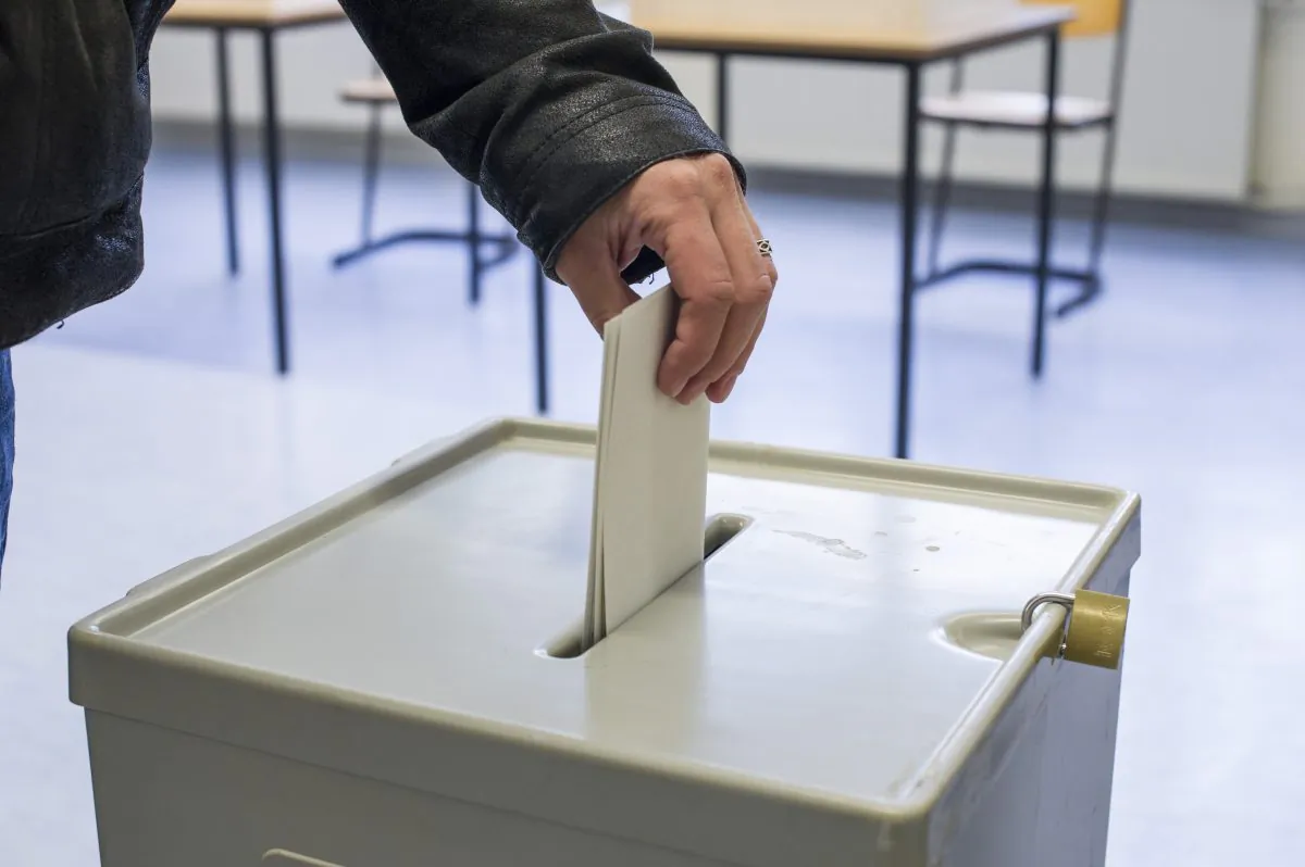 A voter puts his ballot in a ballot box at a primary school in Halle, Germany, on Sept. 22, 2013. (Jens Schlueter/Getty Images)