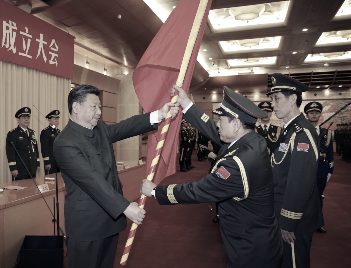 (L–R) Chinese Communist Party leader Xi Jinping gives a military flag to Wei Fenghe, commander of the Rocket Force of the Chinese People's Liberation Army (PLA), and Wang Jiasheng, political commissar of the Rocket Force, in Beijing on Dec. 31, 2015. (Li Gang/Xinhua via AP)