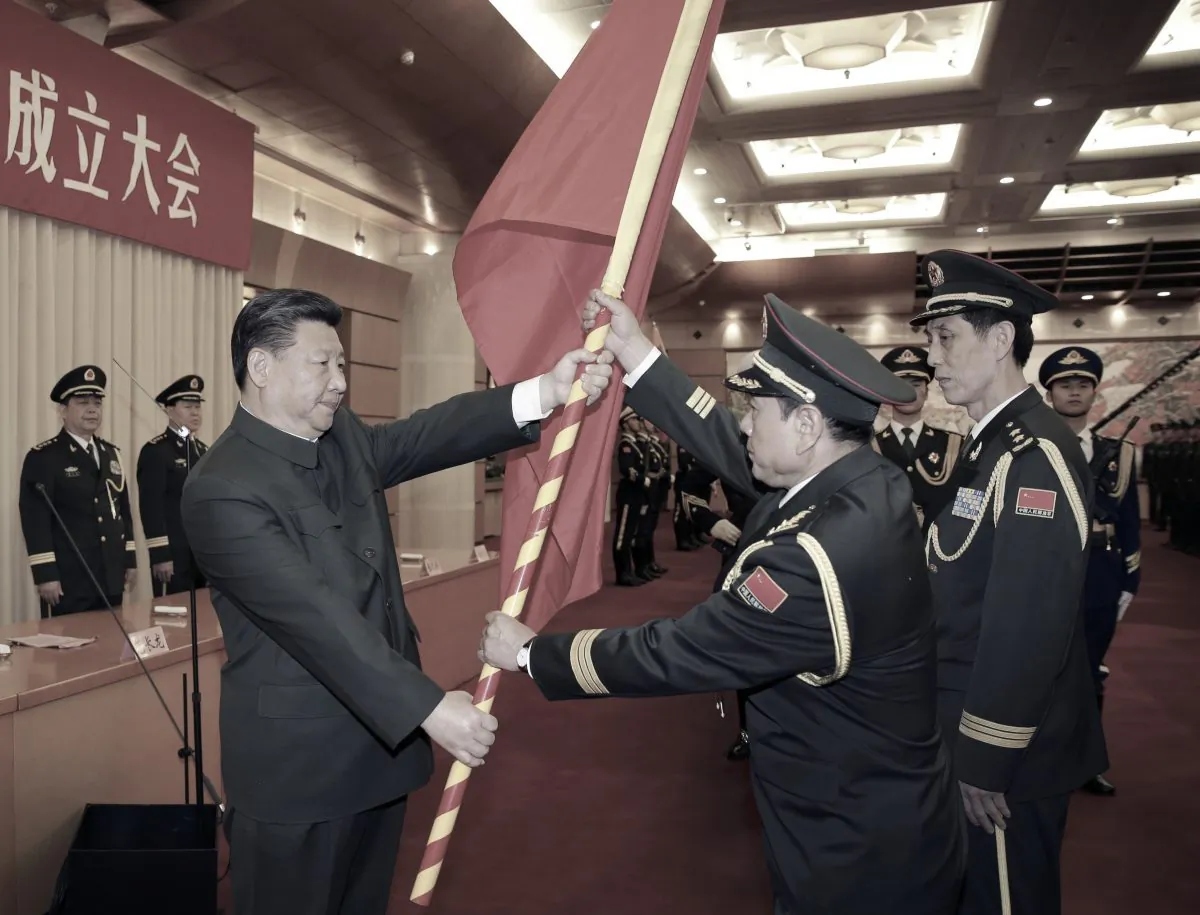 (L–R) Chinese Communist Party leader Xi Jinping gives a military flag to Wei Fenghe, commander of the Rocket Force of the Chinese People's Liberation Army, and Wang Jiasheng, political commissar of the Rocket Force, in Beijing on Dec. 31, 2015. (Li Gang/Xinhua via AP)