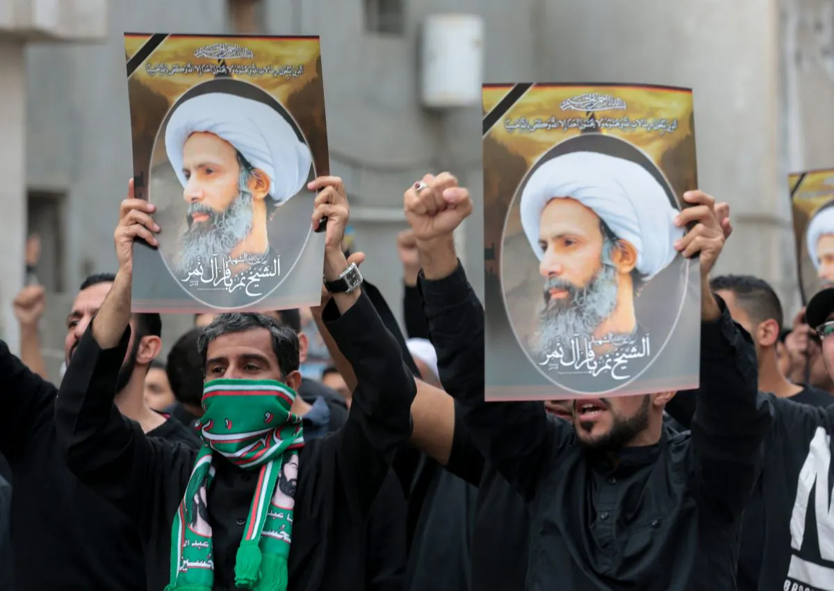 Saudi Shiite men hold placards bearing portraits of Shiite cleric Nimr al-Nimr during a protest on Jan. 8, 2016, in the eastern coastal city of Qatif, against his execution by Saudi authorities in Jan. 2. Nimr was a driving force of the protests that broke out in 2011 in the kingdom's Saudi Eastern Province, an oil-rich region where the Shiite minority of an estimated 2 million people complains of marginalization. (STR/AFP/Getty Images)