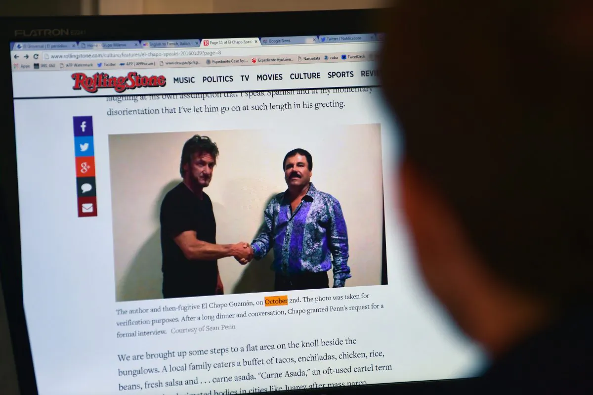 A man reads an article about drug lord Joaquin Guzman, aka "El Chapo," showing a picture of him (R) and American actor Sean Penn on the website of Rolling Stone magazine, in Mexico City, on Jan. 10, 2016. (Alfredo Estrella/AFP/Getty Images)
