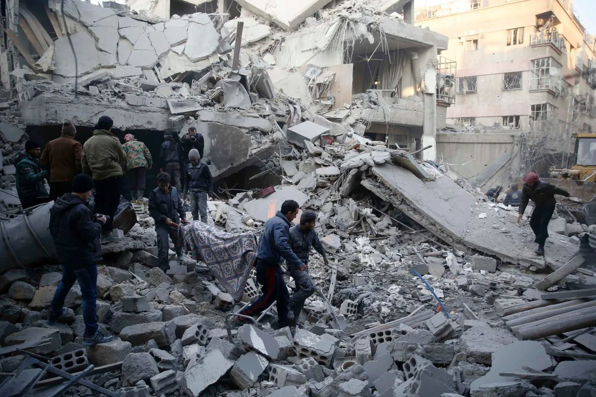 Syrians and civil defense workers evacuate victims from the rubble of a destroyed building following air strikes on the Eastern Ghouta town of Douma, a rebel stronghold east of the capital Damascus, on Jan. 10. (SAMEER AL-DOUMY/AFP/Getty Images)
