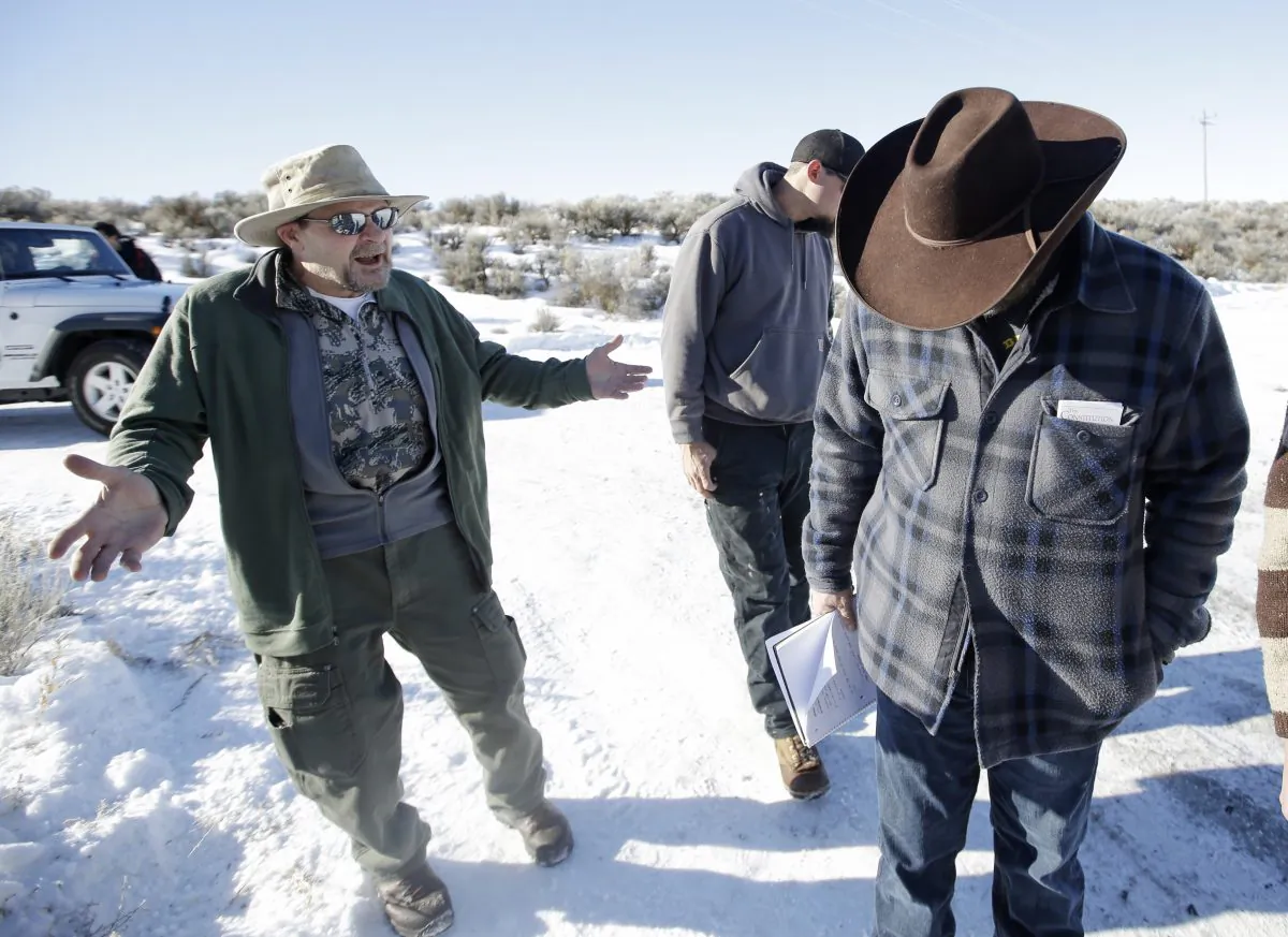 Burns resident Steve Atkins (L) talks with Ammon Bundy (R), one of the sons of Nevada rancher Cliven Bundy, following a news conference at Malheur National Wildlife Refuge near Burns, Ore., on Jan. 8, 2016. Bundy, the leader of a small, armed group occupying a national wildlife refuge in Oregon says the activists have no immediate plans to leave. Atkins said, the majority of the people of Burns wanted them to leave. (AP Photo/Rick Bowmer)