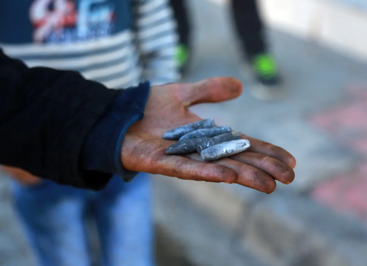 A man shows used bullets near a barricade set up by the militants of the Kurdistan Workers' Party (PKK) in Nusaybin, Turkey, on Dec. 25, 2015. Tens of thousands of civilians in southeast Turkey have been caught in the middle as government forces and Kurdish militants battle it out in urban areas—violence that has shattered hopes of reviving peace talks. Turkish security forces launched a large-scale operation last week hoping to rout militants linked to the outlawed PKK, and say more than 180 of them have been killed. Thousands of troops and tanks have been sent to crush pockets of resistance across mainly Kurdish districts, where PKK fighters and youth have set up trenches to keep them at bay. (AP Photo/Murat Bay)