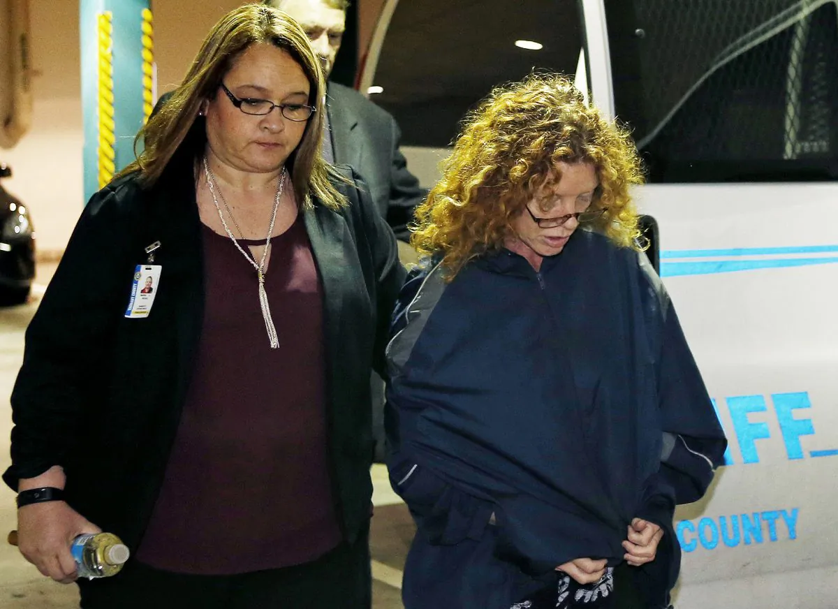 Tonya Couch (R) is escorted into Tarrant County Jail in Fort Worth, Texas, on Jan. 7, 2016. Couch, mother of a fugitive teenager known for using an "affluenza" defense in a deadly drunken-driving case, waived extradition and was sent to Texas from California to face a charge of helping her son evade capture. (Paul Moseley/Star-Telegram via AP)