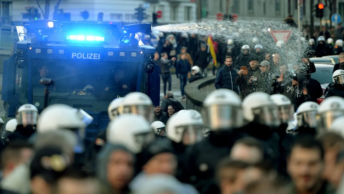 Police drive back right-wing demonstrators using a water cannon during protests in Cologne, Germany, Saturday Jan. 9, 2016. (Monika Skolimowska/dpa via AP)