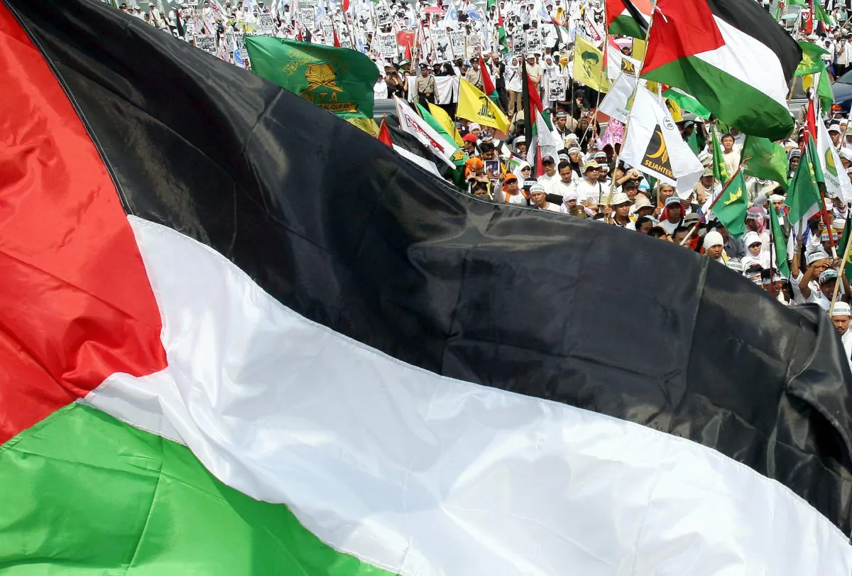 Protesters wave Palestinian flags as they display anti-US and Israeli placards during a demonstration in Jakarta, 06 August 2006. (Jewel Samad/AFP/Getty Images)