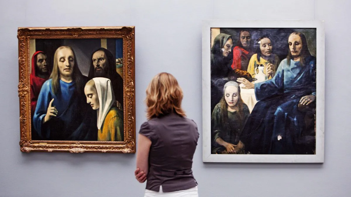 A visitor looks at paintings by Han van Meegeren (1889–1947) in the Boijmans Van Beuningen Museum in Rotterdam on May 11, 2010. (Robin Utrecht/AFP/Getty Images)